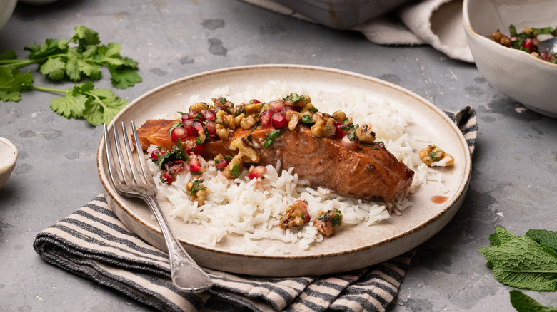 pomegranate glazed salmon on plate on stone table