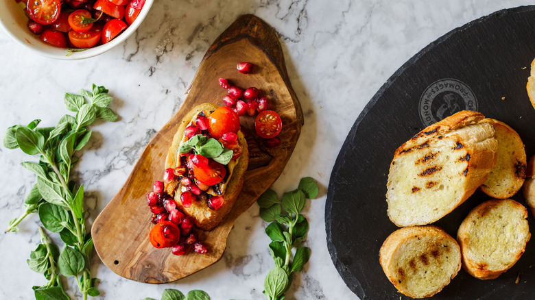 crostini on small board with salsa and toasted bread around