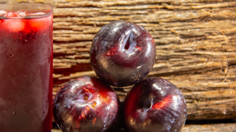 Prune juice next to plums