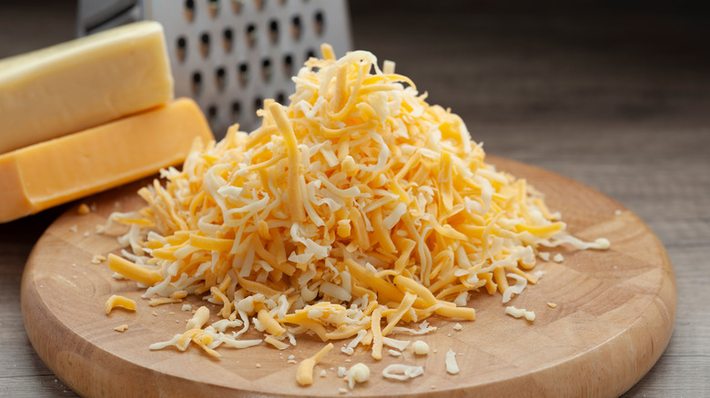 grated cheese on wooden board