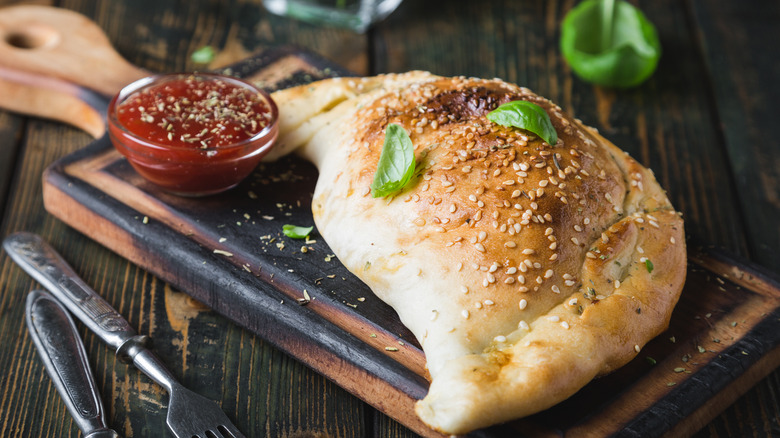 Fried cheese dough pocket with dipping sauce