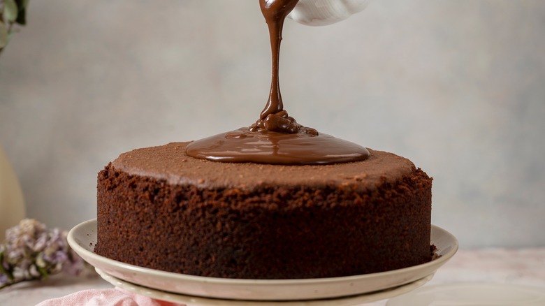 frosting a chocolate cake 