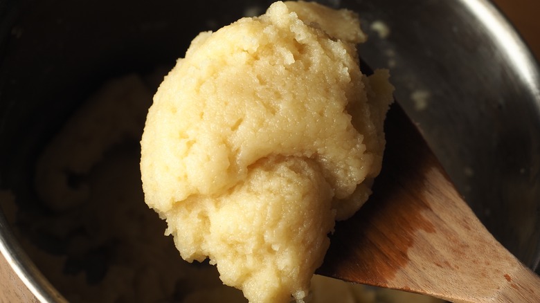 Choux dough on wooden spoon