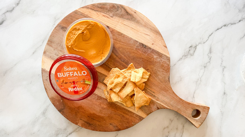 Buffalo hummus on table with chips