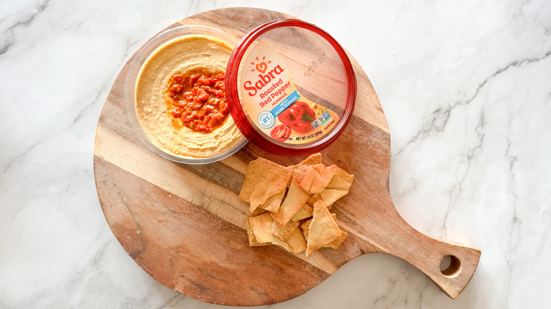 Roasted red pepper hummus on table with chips