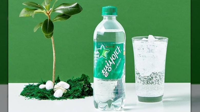 Chilsung Cider bottle beside a glass of soda