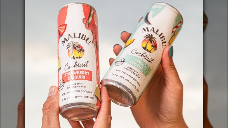 hands holding Malibu canned cocktails