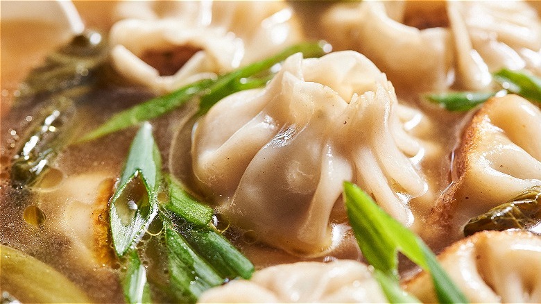 close up of cooked dumpling in broth