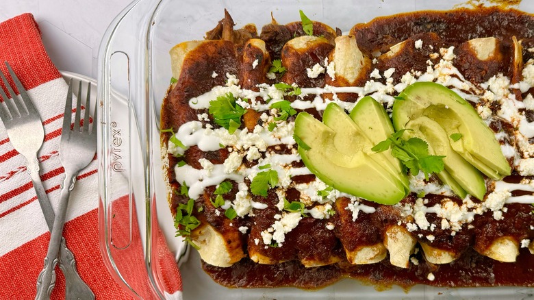 enchiladas in pan with avocados