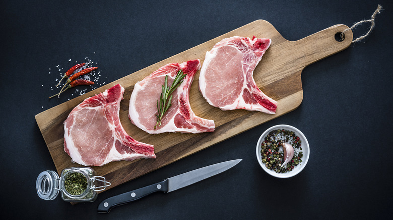 pork chops on cutting board