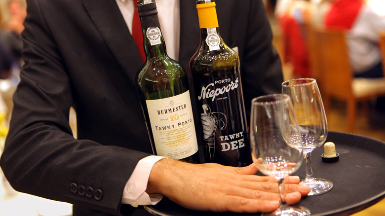 waiter with port bottles