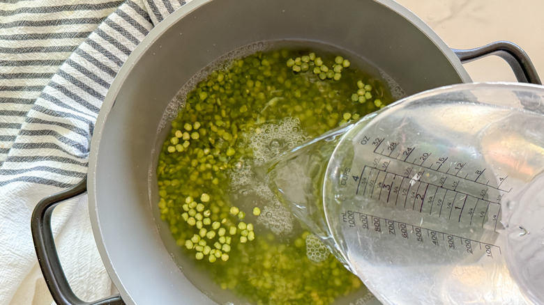 pouring water in pot of split peas