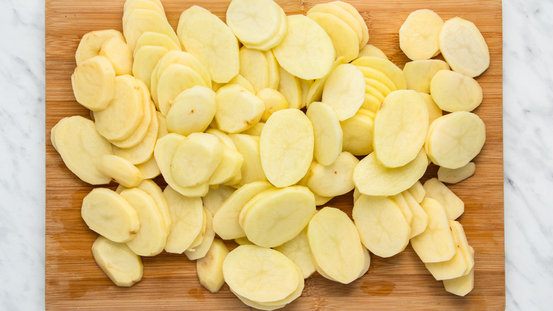 sliced potatoes on cutting board