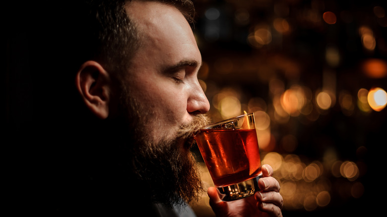 Bearded man savoring his cocktail