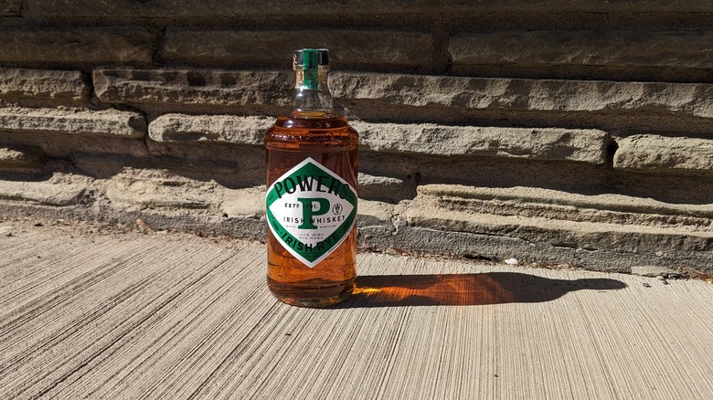 Powers Irish Rye against a wall