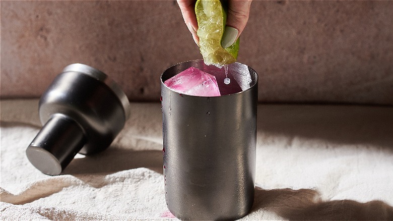 squeezing lime into shaker