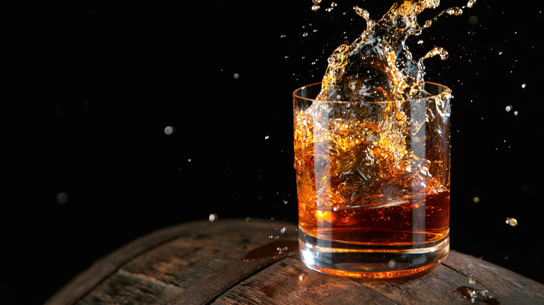 Whiskey splashing into glass