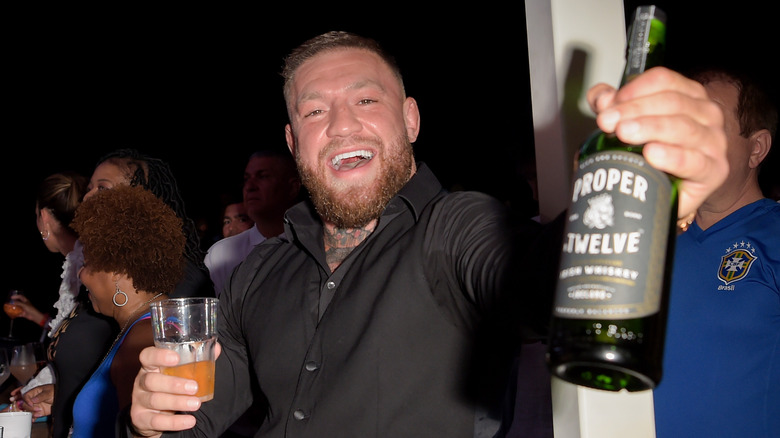Conor McGregor holding whiskey