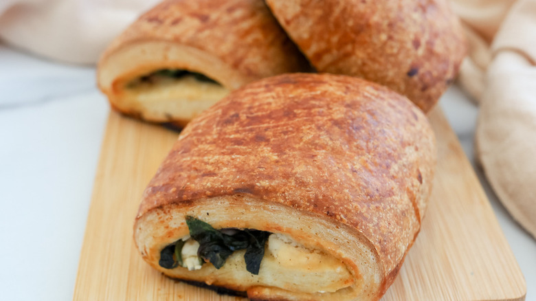 spinach croissants on wooden board