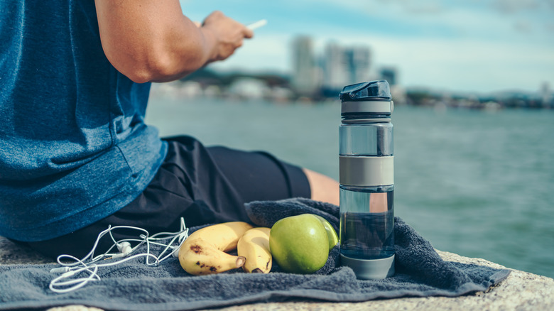 fruit on towel next to person