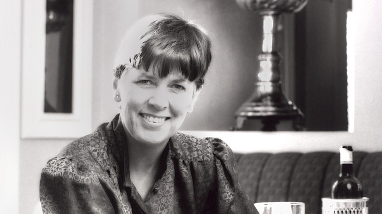 Young Prue Leith smiling in black-and-white photo