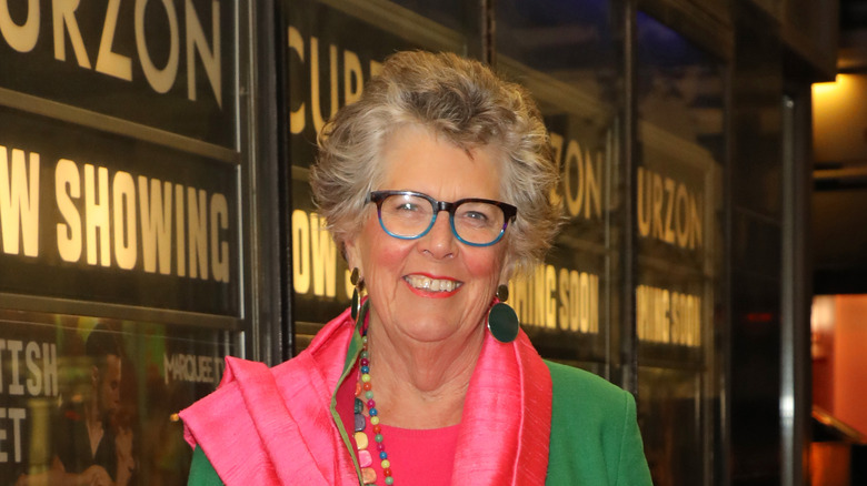 Prue Leith smiling and wearing a pink scarf