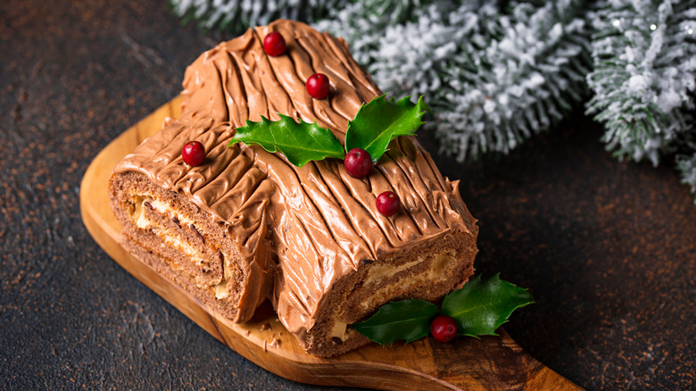 Yule log cake on wooden board