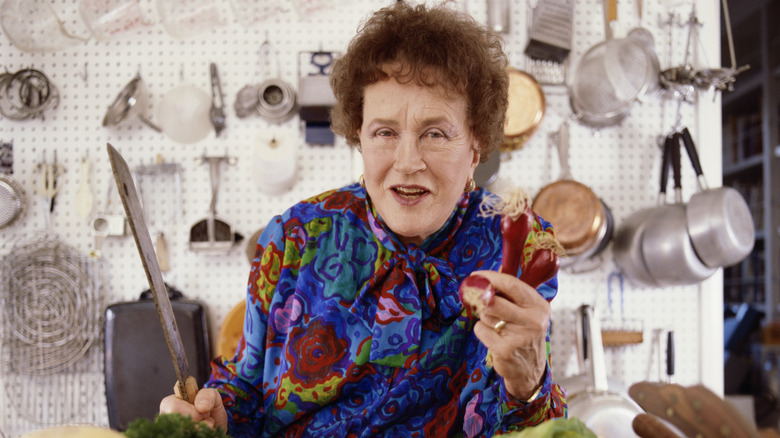 Julia Child standing in kitchen