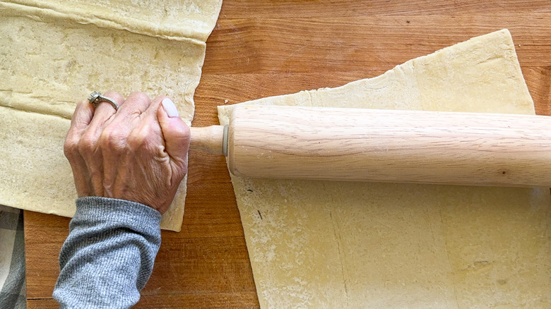 hands rolling out dough