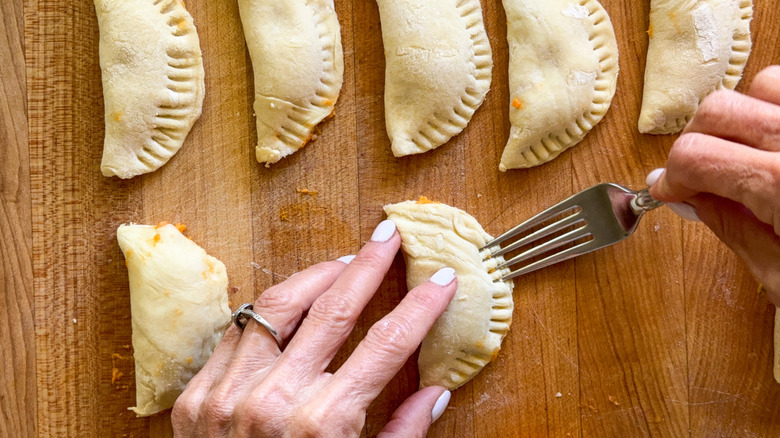 hand using fork to seal