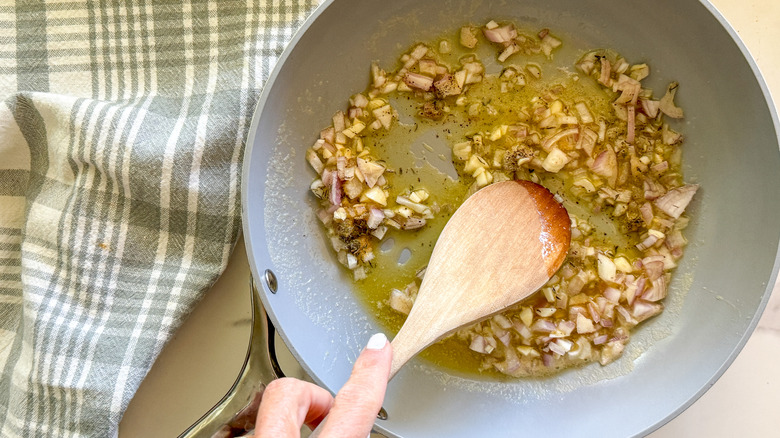 hand stirring the aromatics