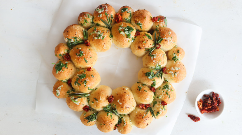 baked wreath garnished with herbs