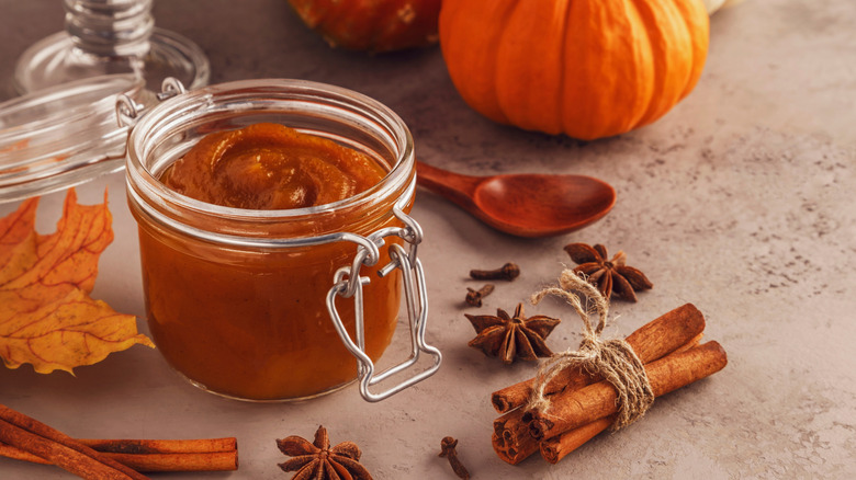 jar of pumpkin butter and scattered fall spices