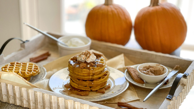 stacked pumpkin pancaked with cinnamon butter