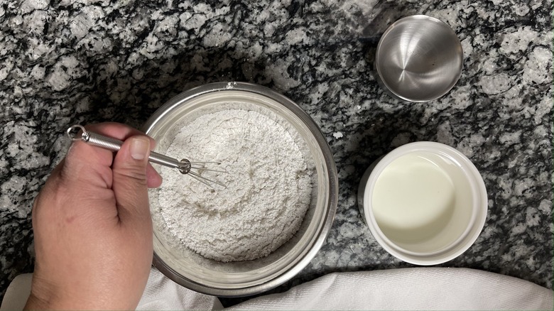 whisking powdered sugar in bowl