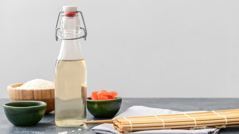 Rice vinegar, rice, and sushi roller mat