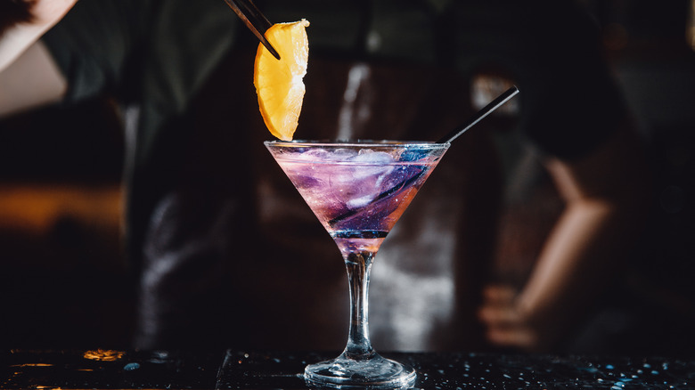 man making purple haze cocktail