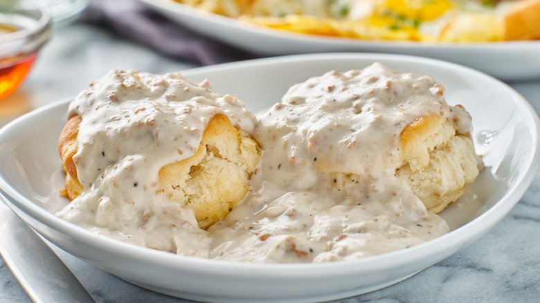 Biscuits and gravy on white plate