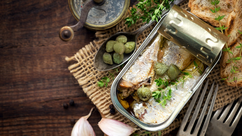 Can of sardines with capers and bread