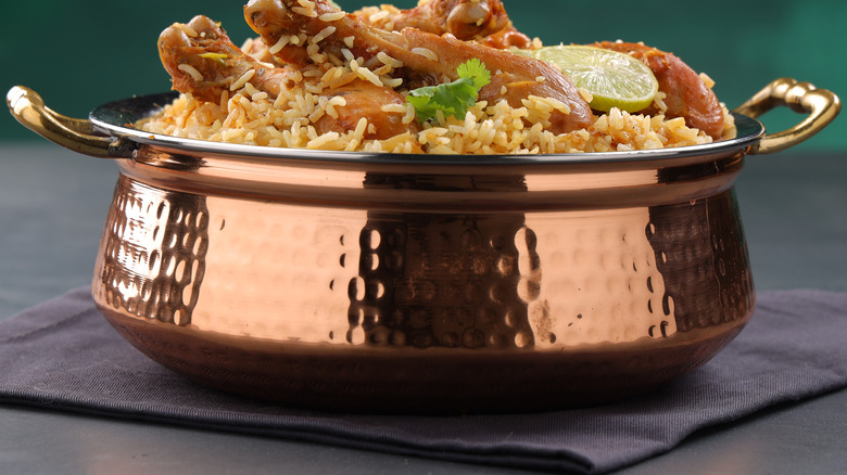 chicken and rice in a copper pot