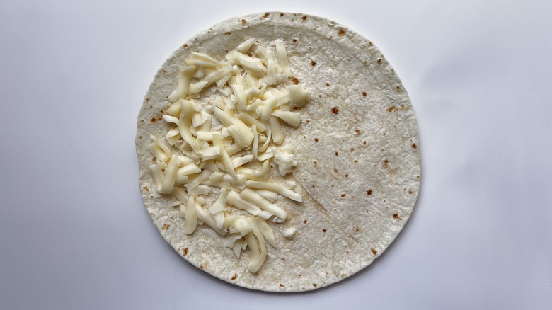 tortilla with grated cheese topping