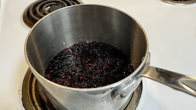 boiling hibiscus petals in saucepan