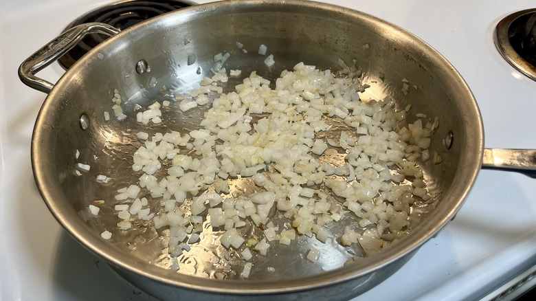 sauteeing diced onions in skillet