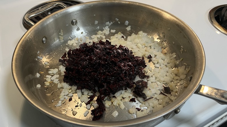 onions and hibiscus in skillet