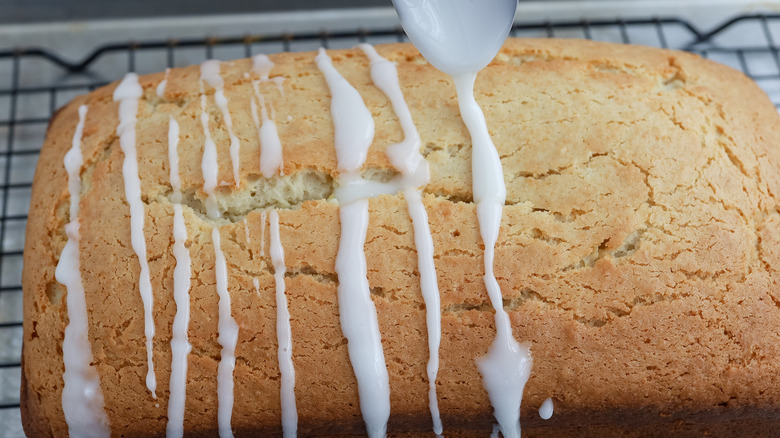 lemon bread on wire rack being glazed