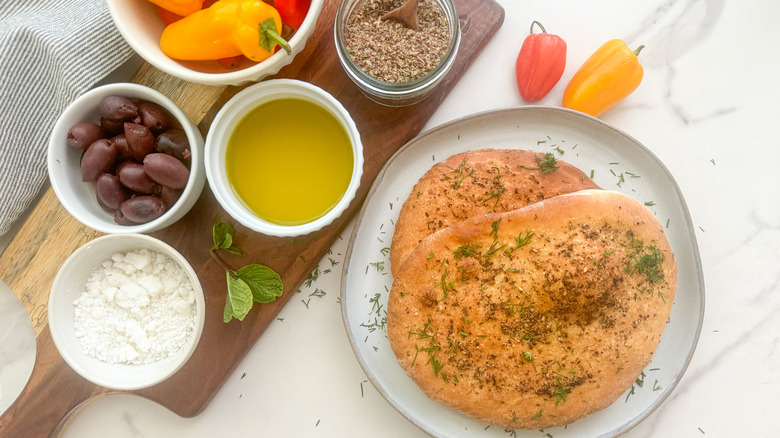 Maneesh bread on a plate next to various toppings