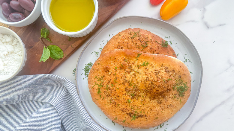 Two slices of maneesh on a white plate