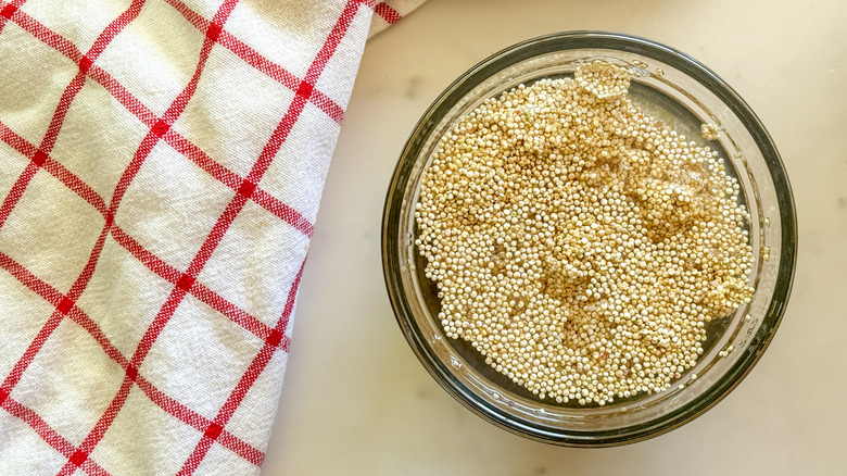 quinoa in bowl of water