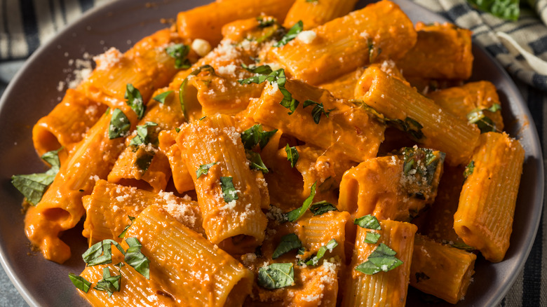 Plate of pasta with creamy vodka sauce and basil