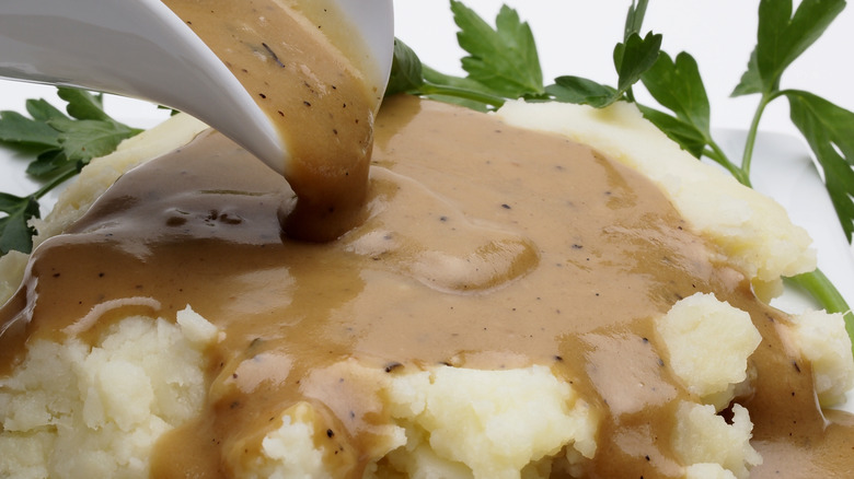 Gravy poured on mashed potatoes